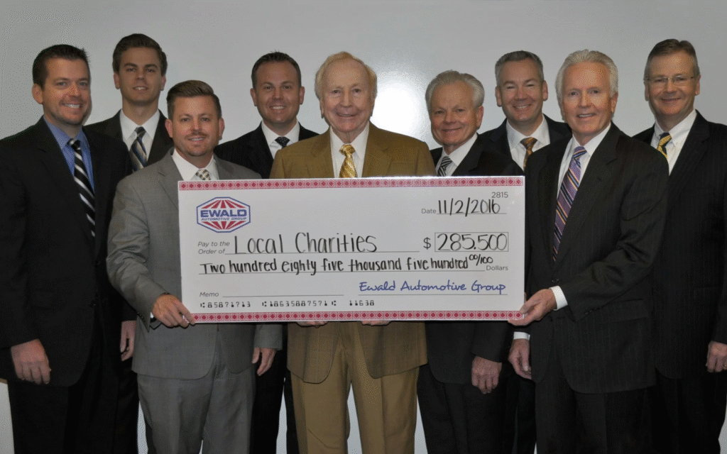 Ewald family members huddled around a donation check made out to local charities.